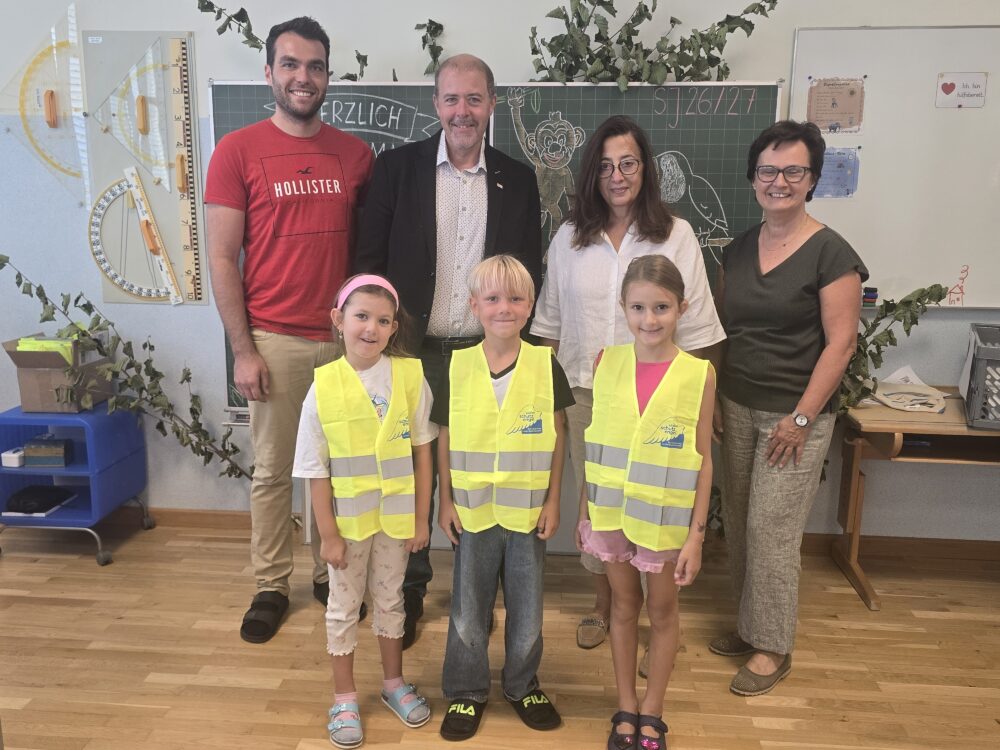 Schulklasse mit Lehrerinnen und Schuldirektor in einem Klassenzimmer in Österreich